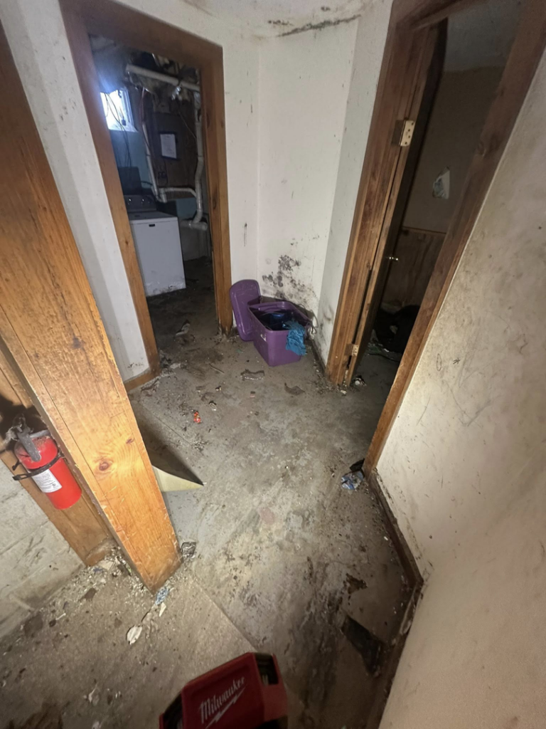 A cluttered and messy basement before junk removal by CleanSite Solutions in Windham, ME.