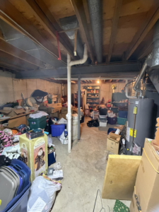 A cluttered basement filled with unwanted items, ready for junk removal by Jack My Junk in St. Charles, MO.