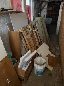 A cluttered basement filled with various junk and debris, ready for removal by Junk Beasts LLC in Marlborough, MA