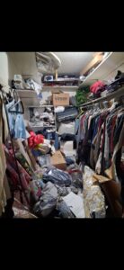 A cluttered closet overflowing with clothes and items, ready for cleanout by T-Rex Service LLC in Cheyenne, WY.