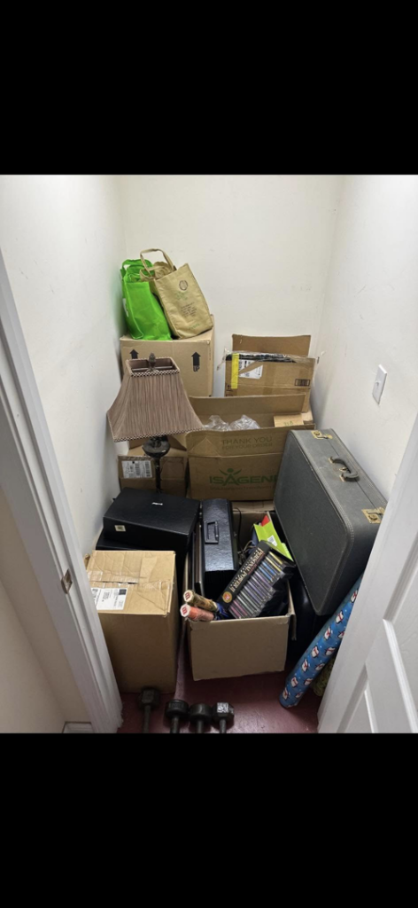 A small closet overflowing with boxes, luggage, and various household items, ready for junk removal by Pop's Pickup Junk & Trash Removal in Roswell, GA.