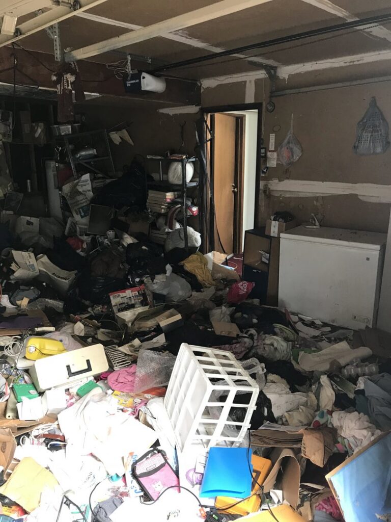 A heavily cluttered garage filled with trash and unwanted items, awaiting a complete cleanout by Down and Dirty Junk Removal in Tacoma, WA.