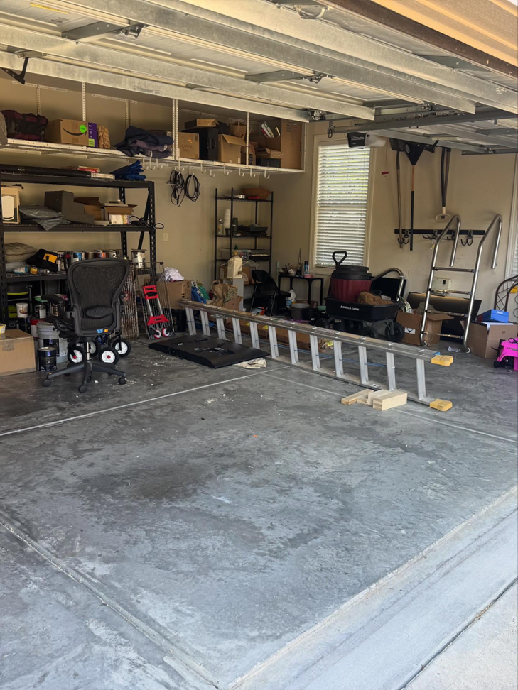 A cluttered residential garage filled with various items before junk removal by Dumpzilla in Raleigh, NC.