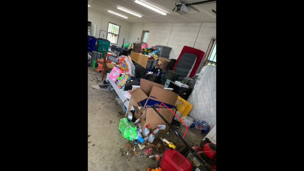A cluttered garage filled with boxes, furniture, and various items, awaiting junk removal in Frederick, MD.