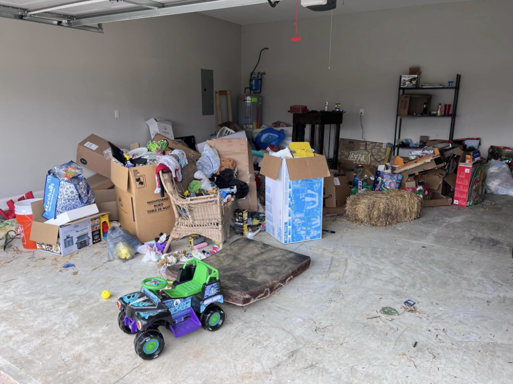 A cluttered garage filled with boxes and unwanted items before junk removal by Haul It All Debris & Junk Removal in Henderson, NV