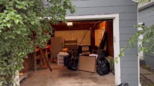 A cluttered garage filled with various items of junk before removal by Junk Haulin Heroes in Bismarck, ND.