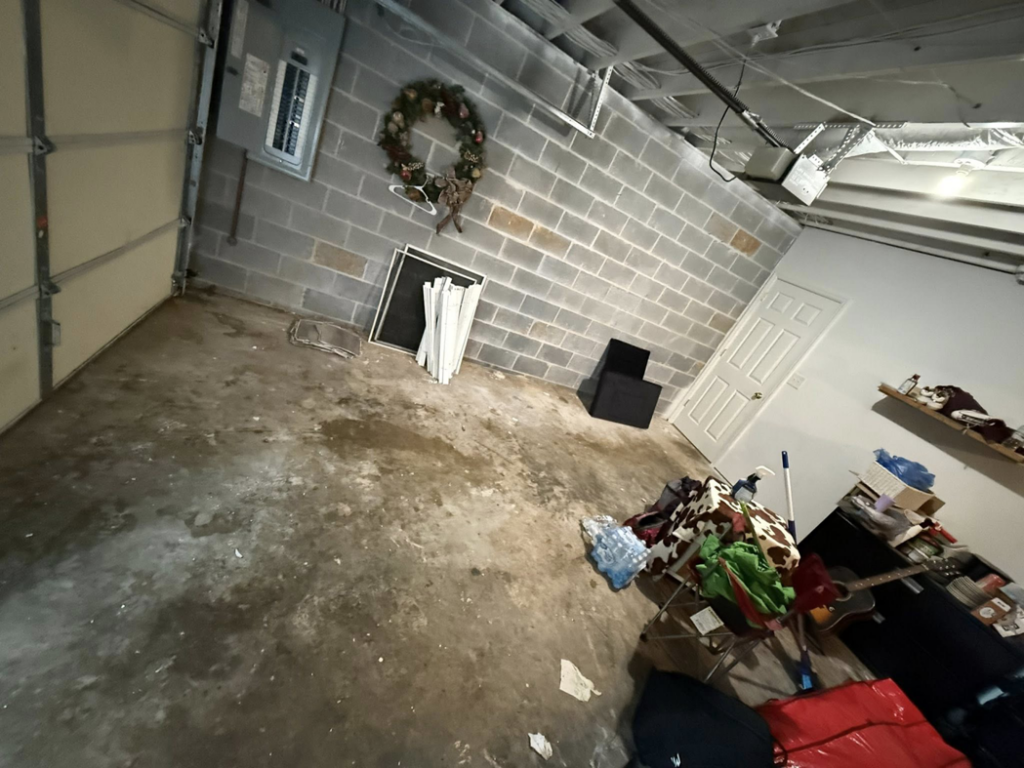 A cluttered garage before junk removal service by Marc & Park Junk Removal, LLC in Birmingham, AL.
