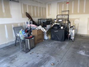 A cluttered garage filled with various items and debris, ready for general junk removal by Redline Hauling in Westerville, OH.