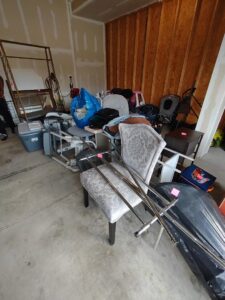 A garage packed with furniture, boxes, and miscellaneous household items, ready for a cleanout service from 1-800-Declutter in Cincinnati, OH.