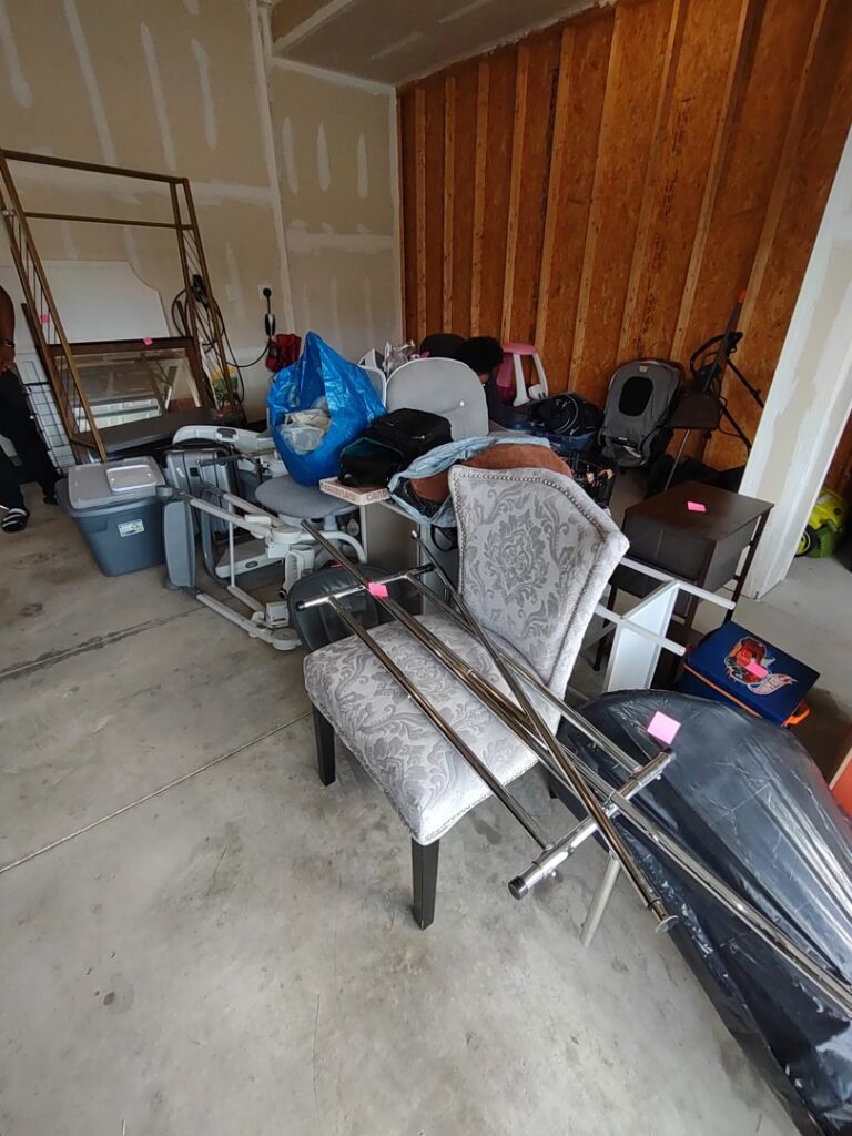 A garage packed with furniture, boxes, and miscellaneous household items, ready for a cleanout service from 1-800-Declutter in Cincinnati, OH.