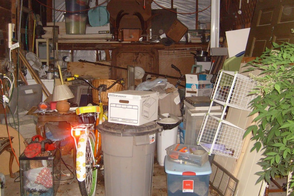 A heavily cluttered garage or storage space requiring a cleanout service from Avery's Junk Removal & Hauling in Trenton, MI.