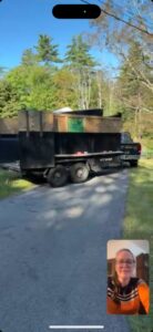 A cluttered garage filled with boxes, cleaning supplies, and a large TV box, indicating a junk removal and cleanout service by Trash King LLC in Peoria, AZ.