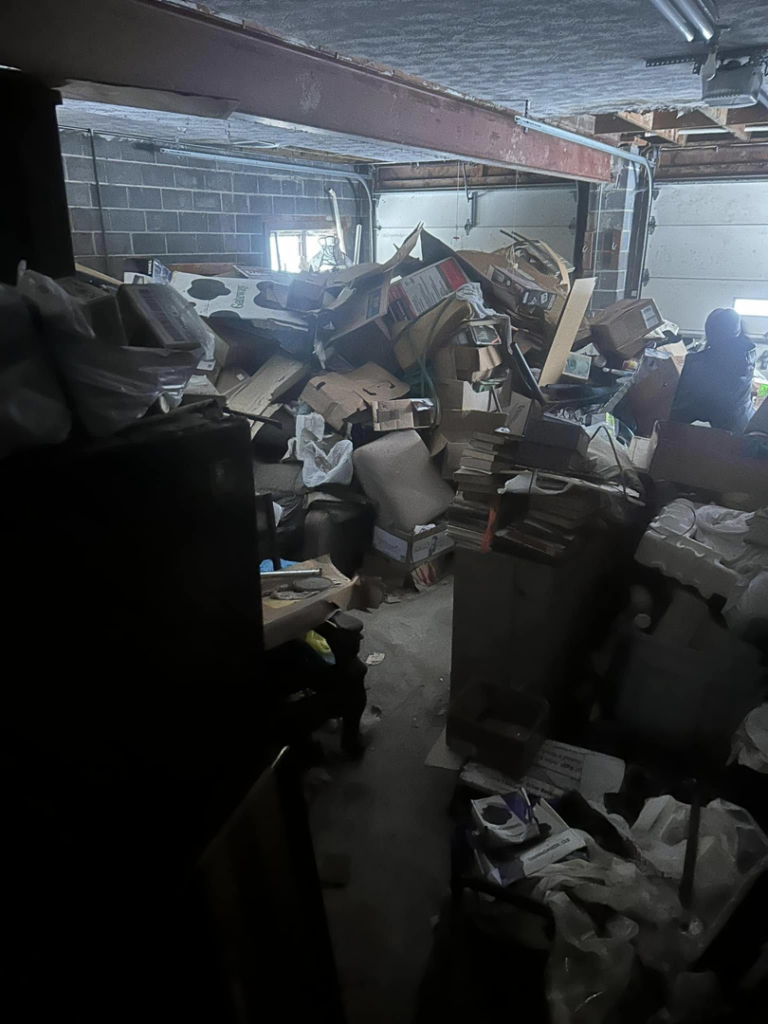 A heavily cluttered garage packed with boxes and items, awaiting general junk removal by White Dumpster in Alliance, OH.