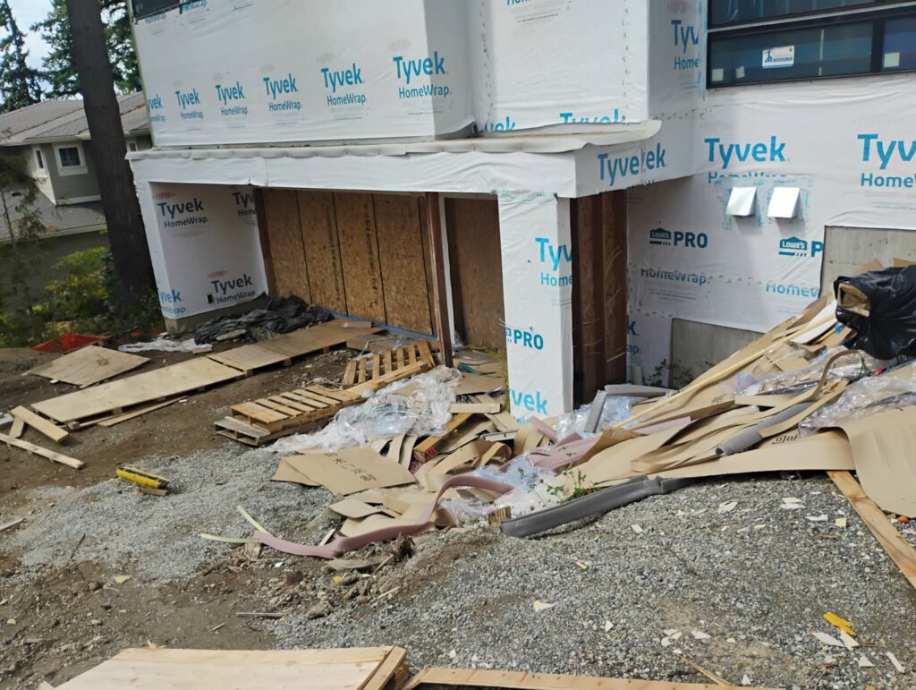 A cluttered garage packed with various household junk, including boxes, toys, and old furniture, ready for removal by JUNK IN THEE TRUNK in Kent, WA.