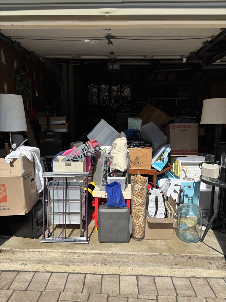 A cluttered garage packed with various household junk and boxes, ready for removal by Got Rubbish in Jersey City, NJ