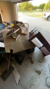 A cluttered garage filled with various household junk, ready for removal by JB'S Junk Removal in Justin, TX.