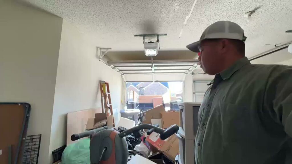 A cluttered garage filled with various items and junk, indicating a clean-out job by Cowtown Waste Removal in Fort Worth, TX.