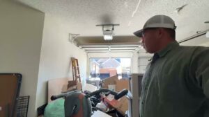 A cluttered garage filled with various items and junk, indicating a clean-out job by Cowtown Waste Removal in Fort Worth, TX.
