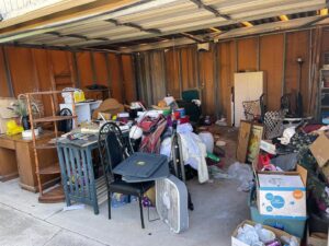 A cluttered garage full of various items and junk, awaiting cleanout by Eastlake Hauling and Junk Removal, LLC in Chula Vista, CA.