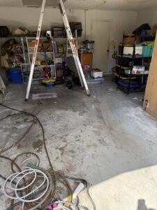 A cluttered garage filled with various items and boxes, indicating a junk removal job for Lightning Bay Junk Removal in Tampa, FL.