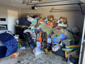A cluttered garage overflowing with household junk and boxes, ready for removal by Okc Junk Haul & Delivery in Oklahoma City, OK.
