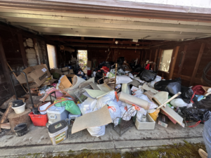 A cluttered garage filled with various junk and debris, ready for removal by Patriot Hauling & Junk Removal LLC in Salem, OR.
