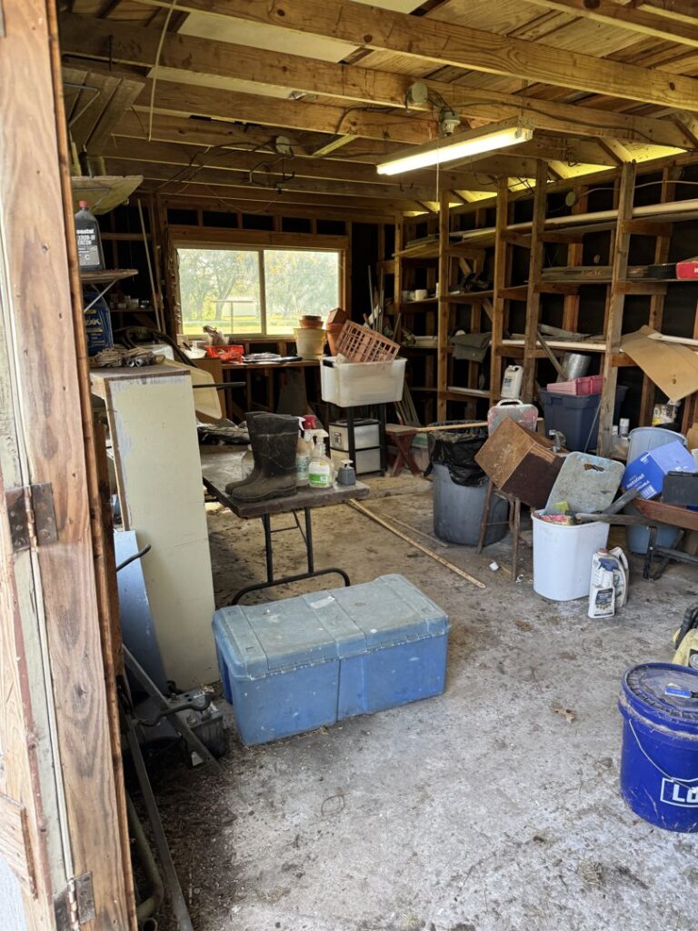 A cluttered garage or shed interior filled with various items ready for junk removal by Clear Your Junk - Pearland, Houston, TX.