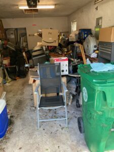 A cluttered garage filled with various household junk items, ready for removal by DUMP 4 U Hauling in Jacksonville, FL.