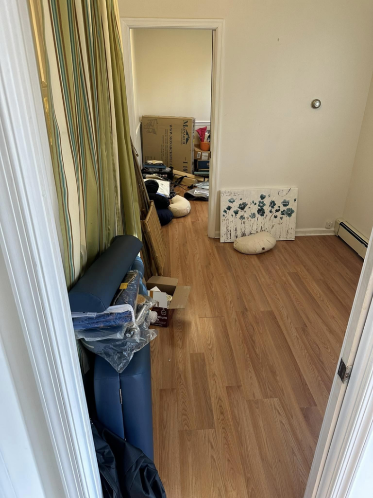 A cluttered hallway with various items needing junk removal by DJ's Hauling & Junk Removal Services in Georgetown, DE.