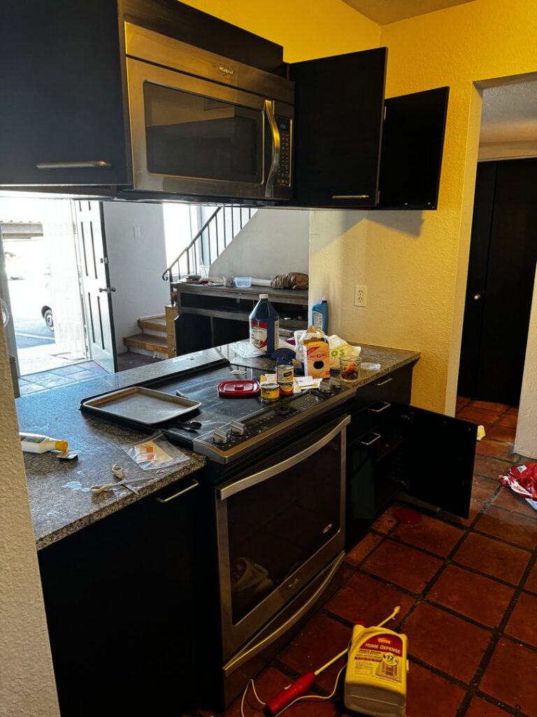 A cluttered kitchen stove and counter area with various items, suggesting a junk removal service by Affinity Bio Solutions in Phoenix, AZ.