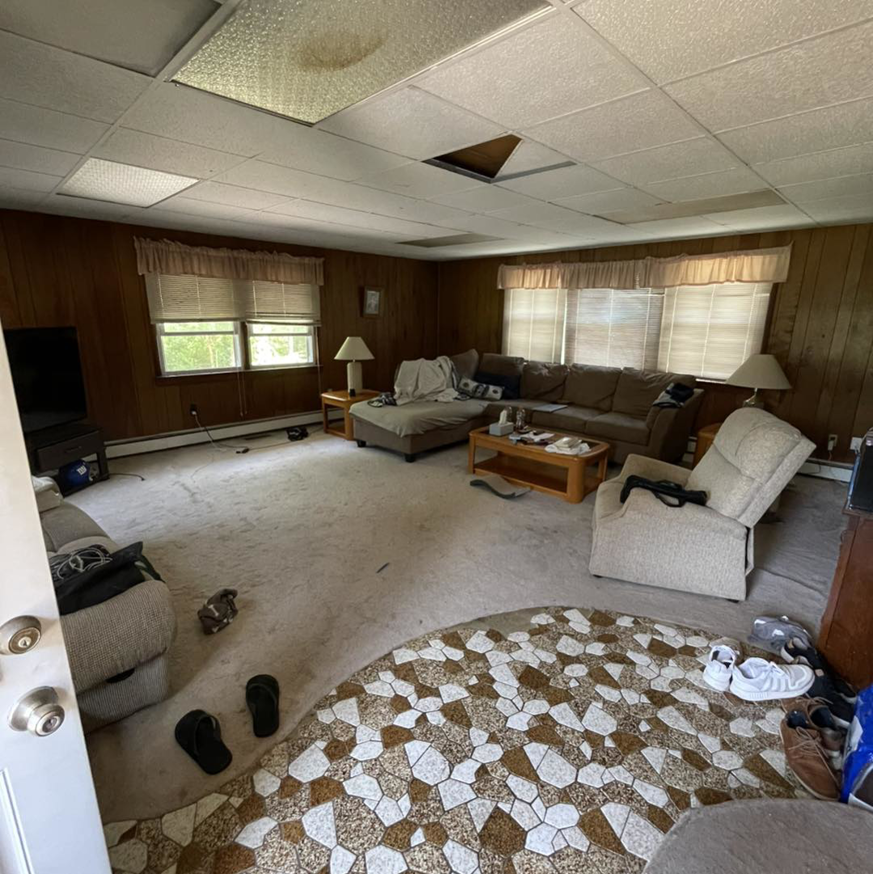 A cluttered living room with old furniture and items, ready for junk removal by LOCAL BOYS in Mays Landing, NJ.