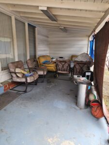 A cluttered patio area with old furniture and a grill, ready for general junk removal by BumbleBee Junk in Sun Valley, CA