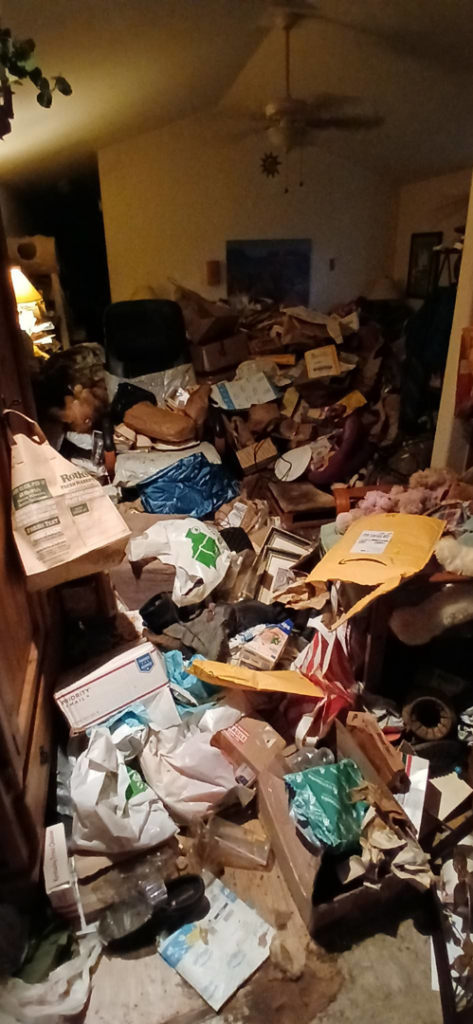 A room completely filled with boxes, bags, and various clutter before a hoarder cleanout service by AG Junk Haulers in Salem, OR.