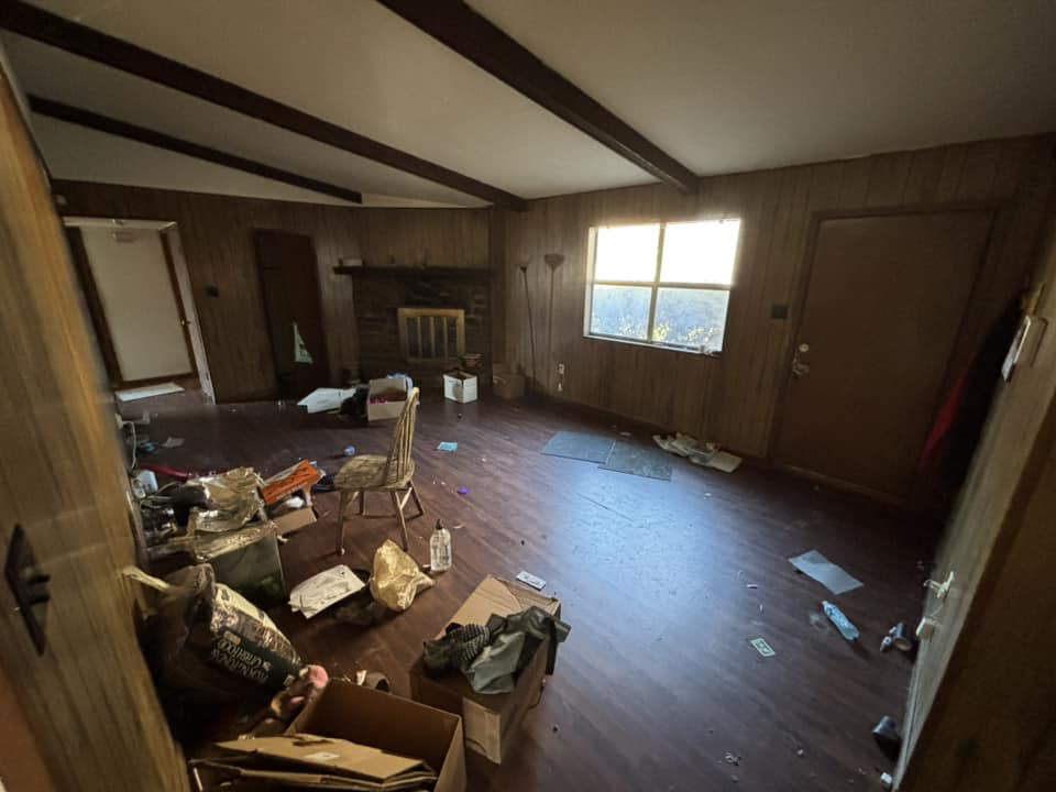 A cluttered room with debris and boxes on the floor, indicating a need for junk removal services from Primo Operations in North Little Rock, AR.