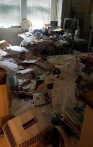 Severely cluttered room before junk removal by T.R. Wess- Queen of Clutter LLC in Rockford, IL.