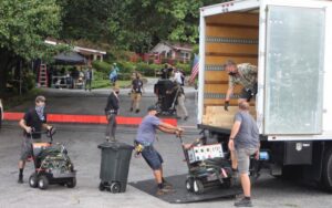 A cluttered room filled with various household junk, including furniture, lamps, and boxes, ready for removal by JUNK IN THEE TRUNK in Kent, WA.