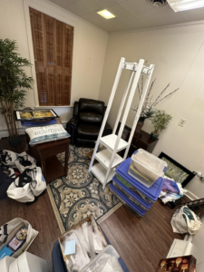 A cluttered room with furniture and various items ready for junk removal by DJ's Hauling & Junk Removal Services in Georgetown, DE.