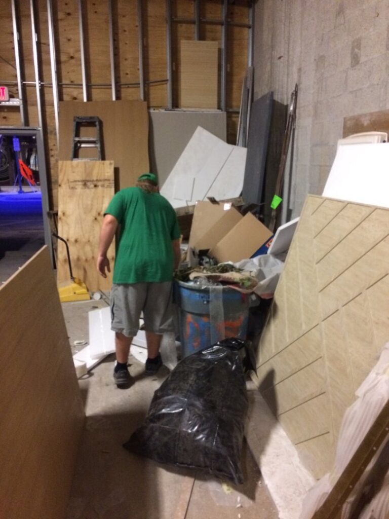 A cluttered room filled with construction debris and junk awaiting removal by Gator Junk Removal in Miami, FL.