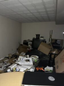 A cluttered room filled with boxes, an old television, and various items, ready for junk removal by Vatter Hauling Service in Lancaster, PA.