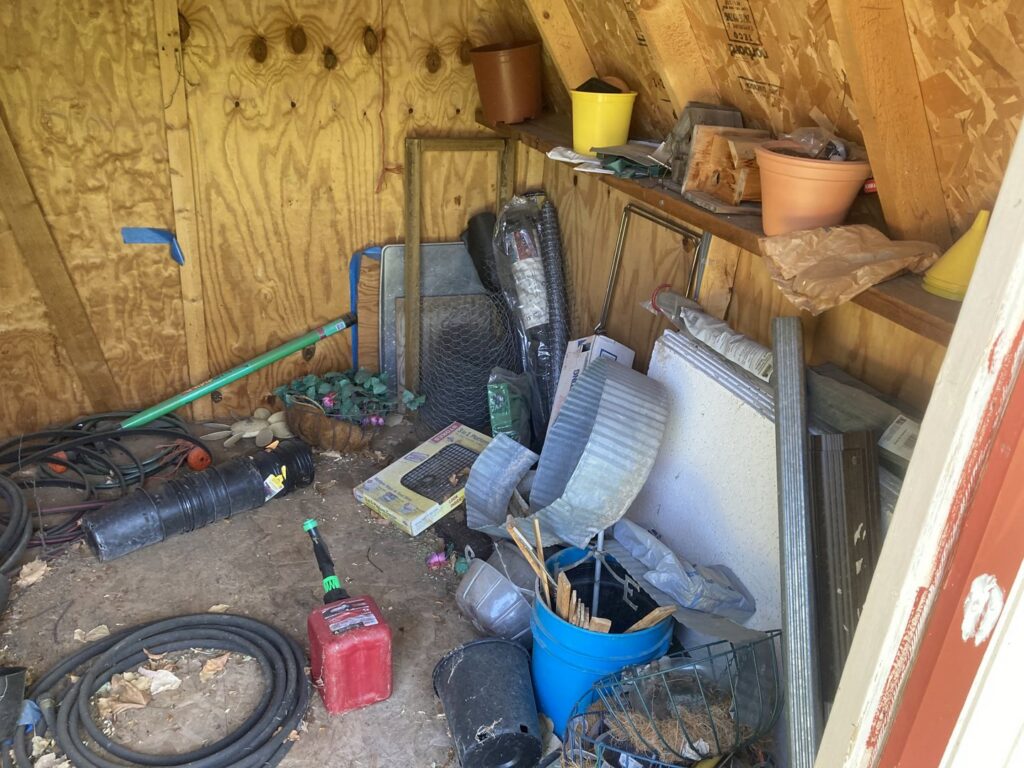 A cluttered shed interior with various items ready for junk removal by Trash It All Hauling And Junk Removal LLC in Fort Collins, CO.