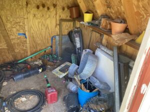 A cluttered shed interior with various items ready for junk removal by Trash It All Hauling And Junk Removal LLC in Fort Collins, CO.