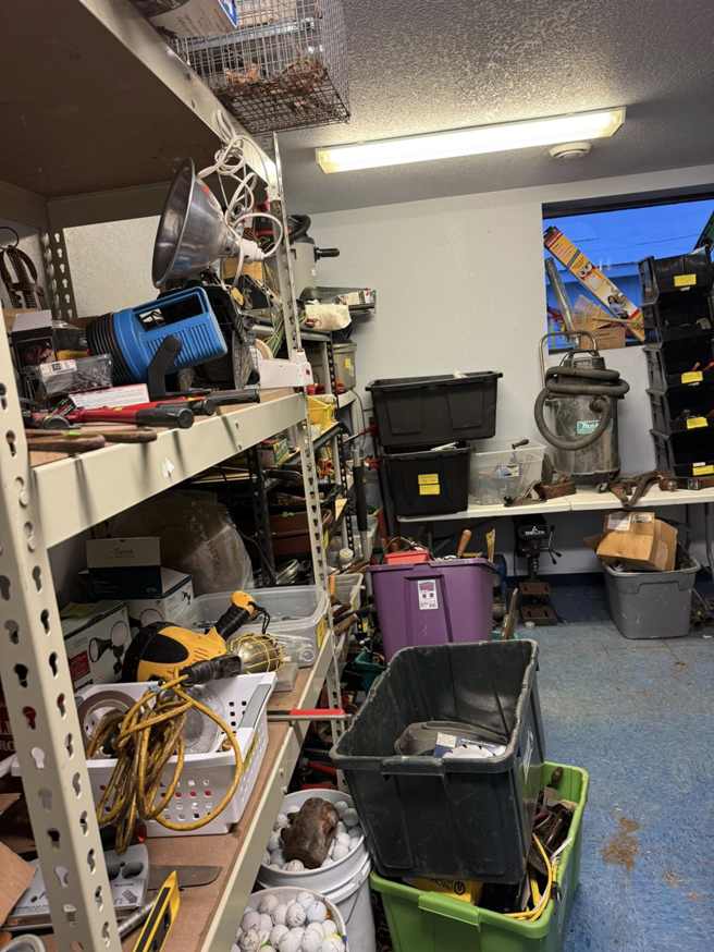 A cluttered storage room with shelves, tools, and boxes, ready for cleanout by Kersten Family Junk Removal in Eau Claire, WI.