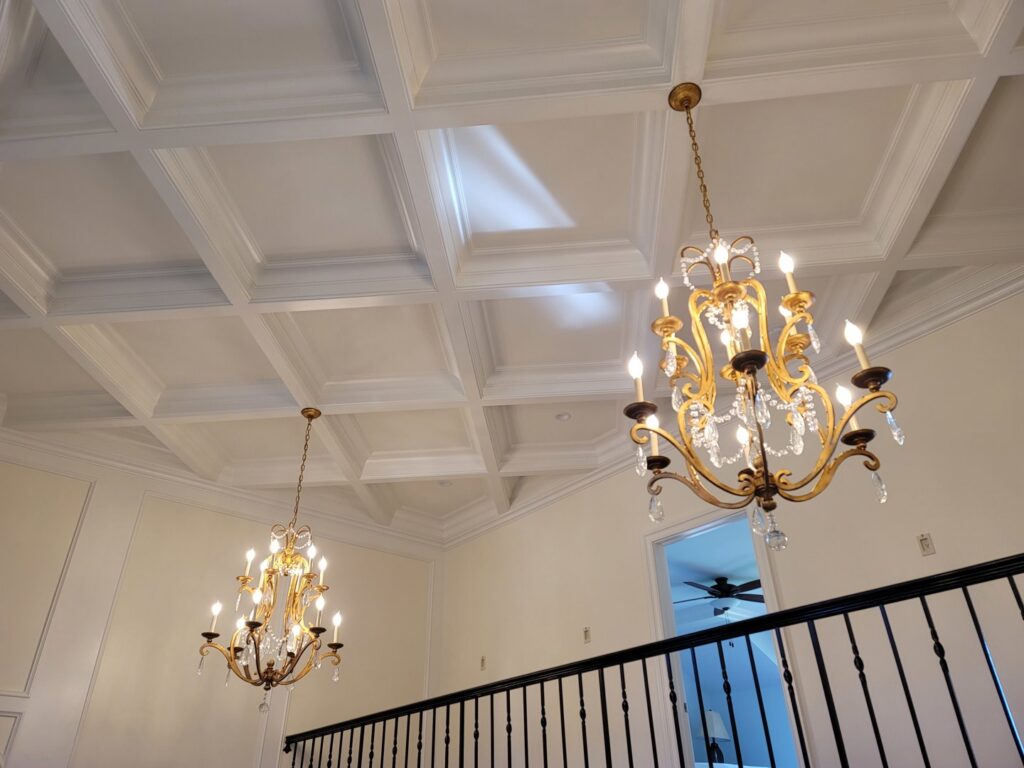 A stunning coffered ceiling with two ornate chandeliers installed by Painting Pros of Knoxville in Knoxville, TN.