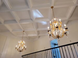 A stunning coffered ceiling with two ornate chandeliers installed by Painting Pros of Knoxville in Knoxville, TN.
