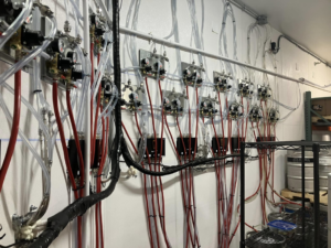Extensive commercial beverage lines and regulators expertly installed in a cooler by Black Tide Beverage in Lakewood, CO.