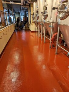 A commercial brewery facility renovation with a new red epoxy floor by Roche Epoxy Floors in Allentown, PA.