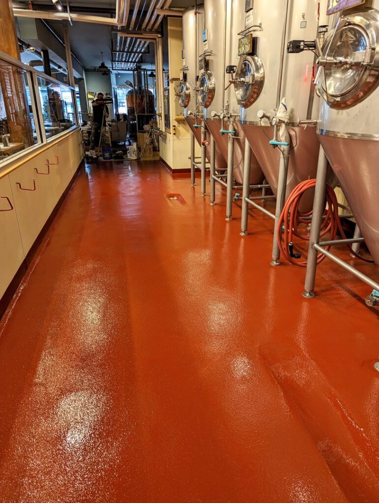 A commercial brewery facility renovation with a new red epoxy floor by Roche Epoxy Floors in Allentown, PA.