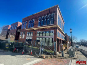 A commercial building under construction with scaffolding and workers by Mendez Contractor Inc in Lynn, MA