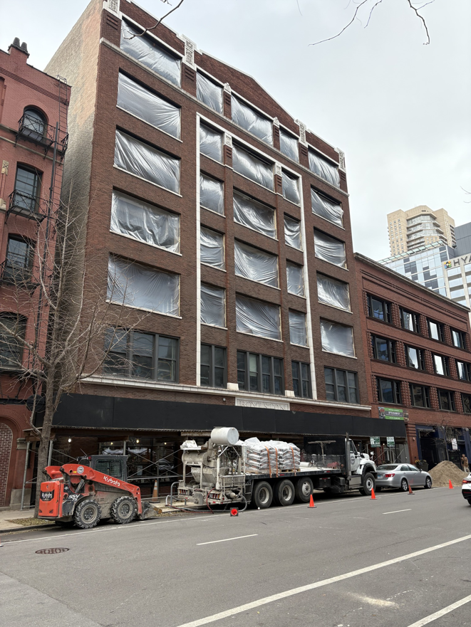 A commercial building construction site with equipment and materials on the street by 3F Construction in Chicago, IL.