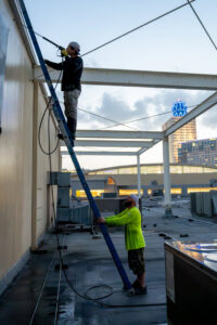 Commercial building exterior pressure washing by Painting Professionals, Inc. in Houston, TX